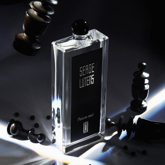 Serge Lutens Poivre Noir Eau de Parfum styled with black pepper and chess pieces