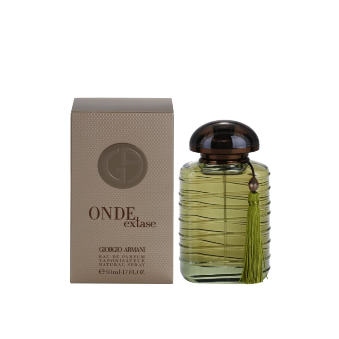 Perfume bottle with a tassel next to its packaging on a white background